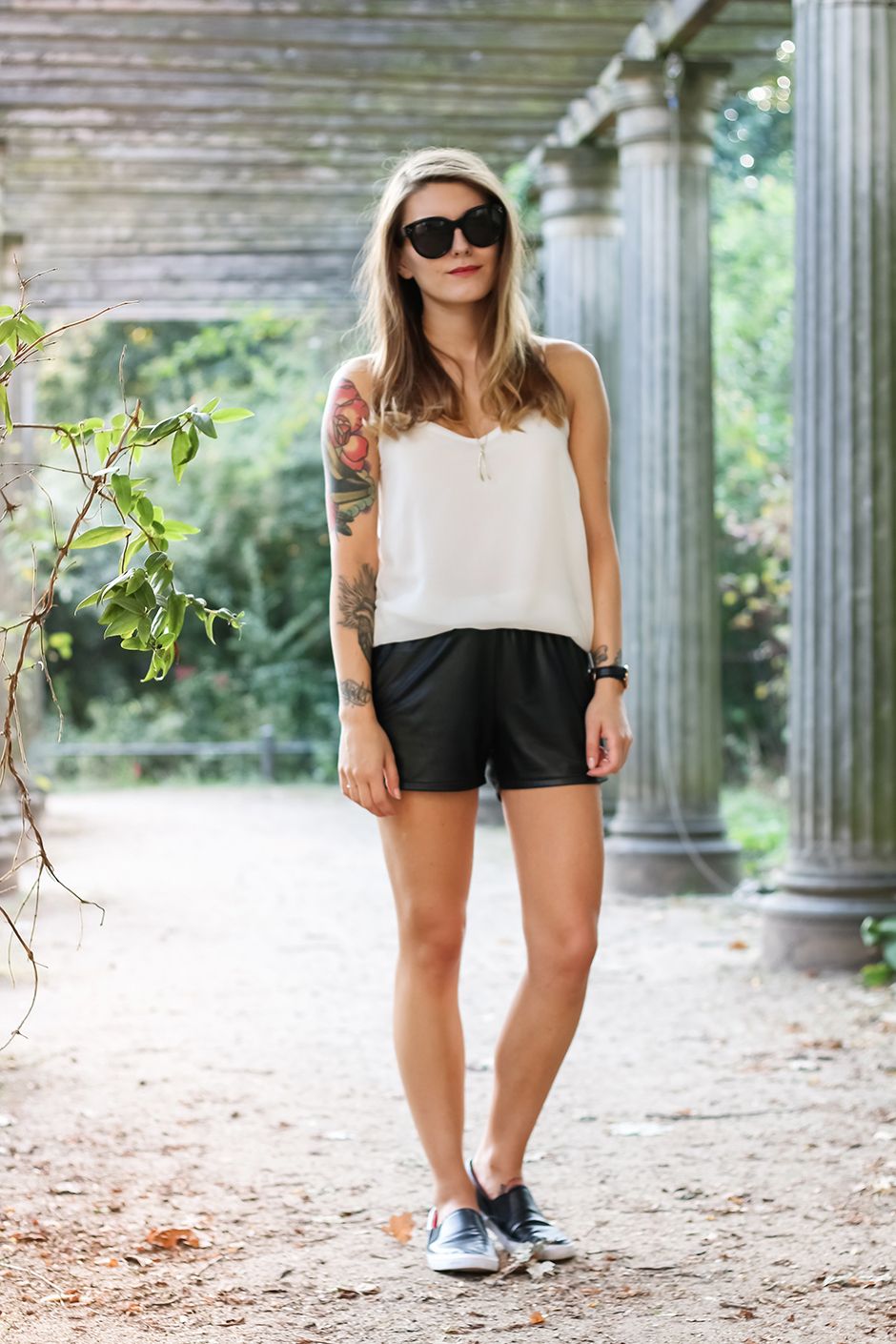 black leather shorts with a white tank top