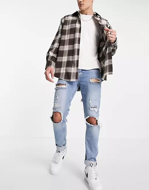 skinny jeans in washed black with heavy rips
